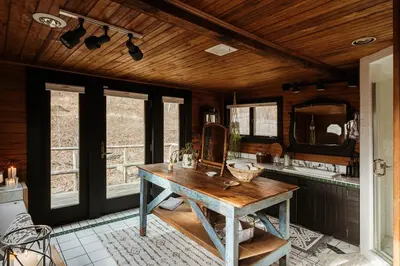 a room with a wooden table and a mirror at Chestnut Hill Farm in Saugerties
