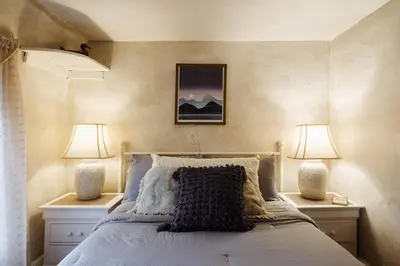 a bedroom with a bed with two lamps on both sides at Chestnut Hill Farm in Saugerties