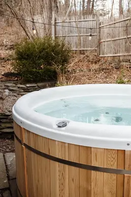 a jacuzzi tub in a yard with a fence at Chestnut Hill Farm in Saugerties