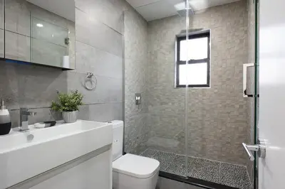 a bathroom with a toilet and a glass shower at 75-5A Luxury 3BR Duplex W D in unit Elevator in New York