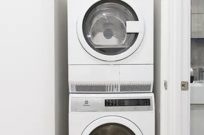 a washing machine and a washer and dryer in a room at 75-5A Luxury 3BR Duplex W D in unit Elevator in New York