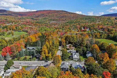 an autumn view of a town in the mountains at Hunter Bungalow - Luxury Cabin, Kid-Friendly in Lanesville