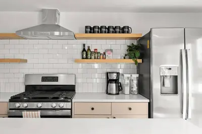 a kitchen with a stove and a refrigerator at Hunter Bungalow - Luxury Cabin, Kid-Friendly in Lanesville