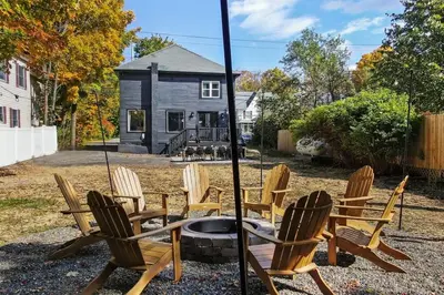 a group of chairs sitting around a fire pit at Hunter Bungalow - Luxury Cabin, Kid-Friendly in Lanesville