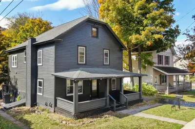 a black house with a gambrel roof at Hunter Bungalow - Luxury Cabin, Kid-Friendly in Lanesville