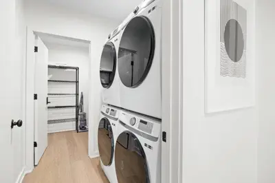 a kitchen with four washing machines in a wall at Pine Hill Chateau - Ski Belleayre, Hunter Mountain in Pine Hill