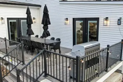 a deck with a table and chairs and umbrellas at Pine Hill Chateau - Ski Belleayre, Hunter Mountain in Pine Hill
