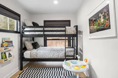 a room with two bunk beds and a table at Pine Hill Chateau - Ski Belleayre, Hunter Mountain in Pine Hill