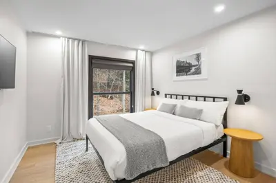 a white bedroom with a bed and a window at Pine Hill Chateau - Ski Belleayre, Hunter Mountain in Pine Hill