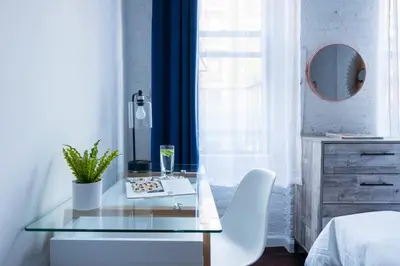 a bedroom with a glass table and white chairs at 83-2FE UES Central Park Newly Furnished Studio in New York