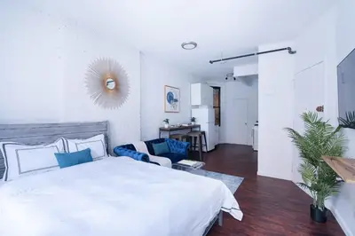 a white bedroom with a bed and a couch at 83-2FE UES Central Park Newly Furnished Studio in New York