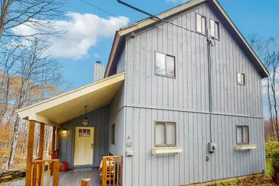 a gray house with a gambrel roof at Farmhouse on the Road in Wilmington