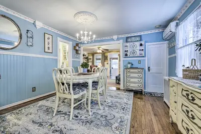 a dining room with blue walls and a table and chairs at Lakefront Home, Close to Mt Southington! in Wolcott