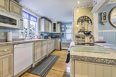 a kitchen with white appliances and blue walls at Lakefront Home, Close to Mt Southington! in Wolcott