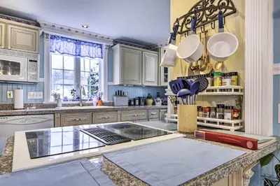 a kitchen with white cabinets and a counter with utensils at Lakefront Home, Close to Mt Southington! in Wolcott