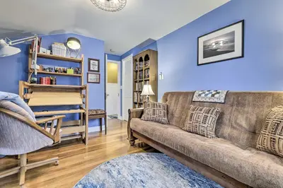 a living room with a brown couch and blue walls at Lakefront Home, Close to Mt Southington! in Wolcott