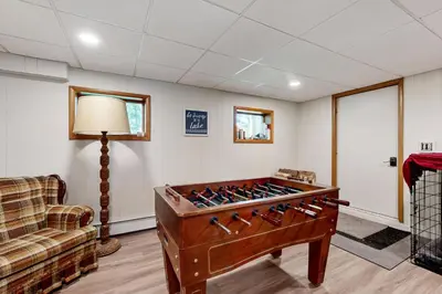 a living room with a foosball table and a couch at Green Mountain Escape in Wilmington