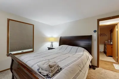 a bedroom with a large bed and a window at Green Mountain Escape in Wilmington