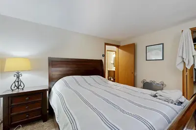 a bedroom with a large bed with a wooden headboard at Green Mountain Escape in Wilmington