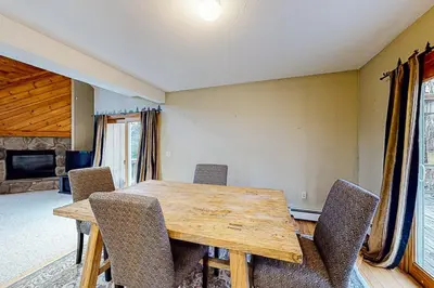 a dining room with a wooden table and chairs at Wooded Wonder in West Dover