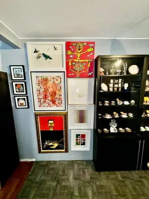 a corner of a room with a refrigerator and pictures at 2 Bedrooms Flat 5 minutes from TIMES SQUARE in Long Island City