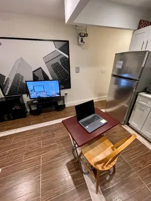 a laptop computer sitting on a table in a kitchen at 2 Bedrooms Flat 5 minutes from TIMES SQUARE in Long Island City