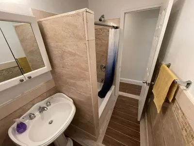 a bathroom with a toilet and a sink and a shower at 2 Bedrooms Flat 5 minutes from TIMES SQUARE in Long Island City