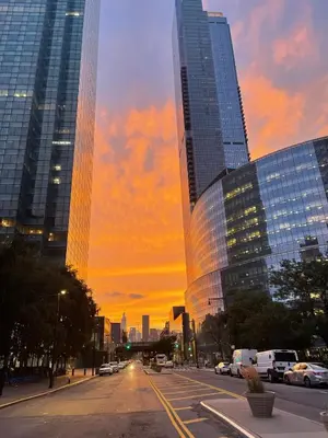 a city street at sunset with tall buildings at 2 Bedrooms Flat 5 minutes from TIMES SQUARE in Long Island City