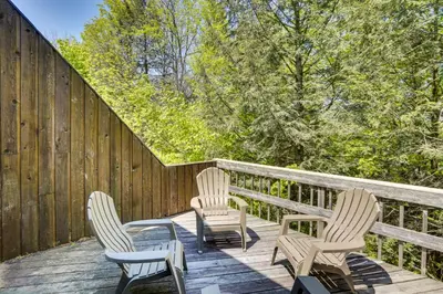 three chairs and a table on a wooden deck at Fantastic 2 family vacation home with EV charger in Windham