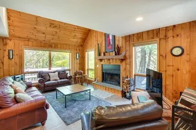 a living room with leather furniture and a fireplace at Fantastic 2 family vacation home with EV charger in Windham