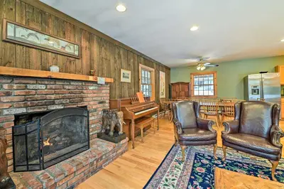 a living room with a fireplace and leather chairs at West Dover Home with Deck about 2 Mi to Mount Snow! in West Dover