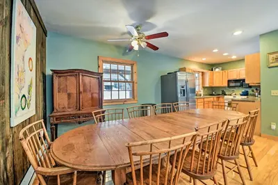 a dining room with a wooden table and chairs at West Dover Home with Deck about 2 Mi to Mount Snow! in West Dover