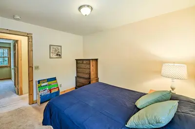 a bedroom with a blue bed and a dresser at West Dover Home with Deck about 2 Mi to Mount Snow! in West Dover