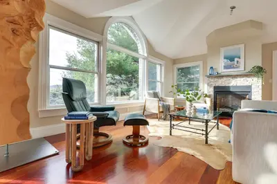 a living room filled with furniture and a fireplace at Hudson River Views Briarcliff Manor Home with Deck in Briarcliff Manor