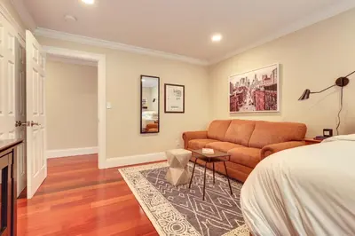 a living room with a bed and a couch at Hudson River Views Briarcliff Manor Home with Deck in Briarcliff Manor