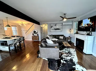 a living room with a couch and a tv at Cozy Cabin on the Lake w/ HotTub in Hopatcong