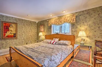 a bedroom with a bed in a room with wallpaper at 1 Mi to Lake Wallenpaupack Spacious Poconos Villa in Hawley