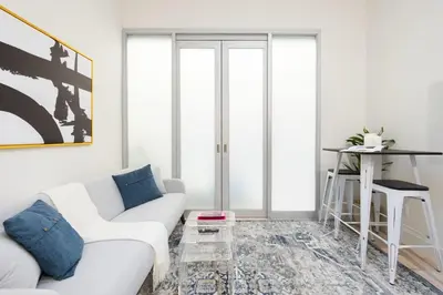 a living room with a white couch and a table at 317-4A NEW Modern 1BR W&D Walk to Central Park in New York