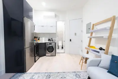 a kitchen with a washer and dryer in a room at 317-4A NEW Modern 1BR W&D Walk to Central Park in New York