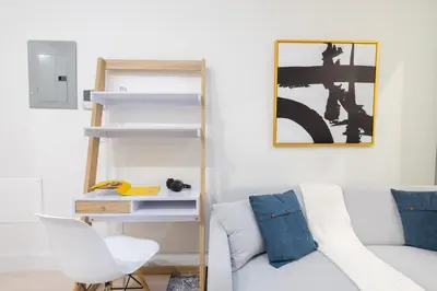 a living room with a white couch and a chair at 317-4A NEW Modern 1BR W&D Walk to Central Park in New York