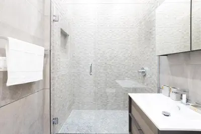a bathroom with a glass shower and a sink at 317-4A NEW Modern 1BR W&D Walk to Central Park in New York