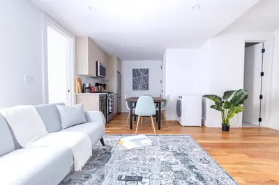 a white living room with a white couch and a table at 323-2 Specious 2BR Williamsburg in Brooklyn