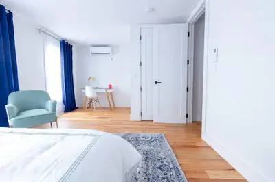 a bedroom with a bed and a blue chair at 323-2 Specious 2BR Williamsburg in Brooklyn