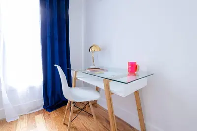 a glass desk with a white chair and a lamp at 323-2 Specious 2BR Williamsburg in Brooklyn
