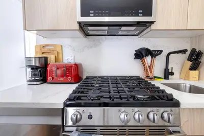 a kitchen with a stove and a red appliance at 323-2 Specious 2BR Williamsburg in Brooklyn