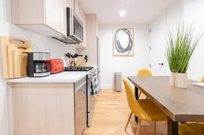 a kitchen and dining room with a table and a counter top at 323-1 Specious 2BR Williamsburg in Brooklyn