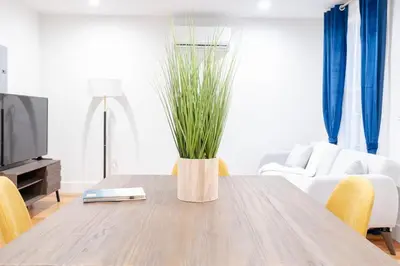 a living room with a wooden table with a vase with grass at 323-1 Specious 2BR Williamsburg in Brooklyn