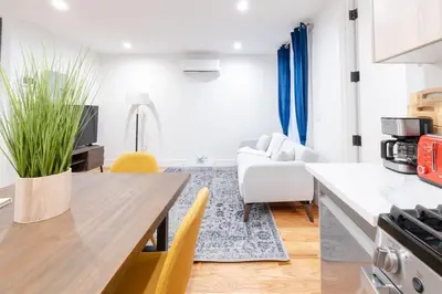 a kitchen and living room with a table and a couch at 323-1 Specious 2BR Williamsburg in Brooklyn