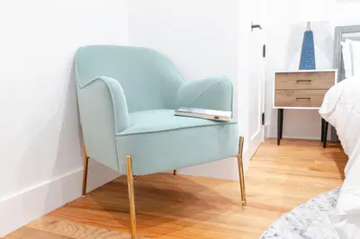 a blue chair with a book on it in a bedroom at 323-1 Specious 2BR Williamsburg in Brooklyn