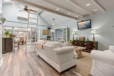 a living room with white furniture and a ladder at Guilford Carriage House at Granite Lodge! in Guilford